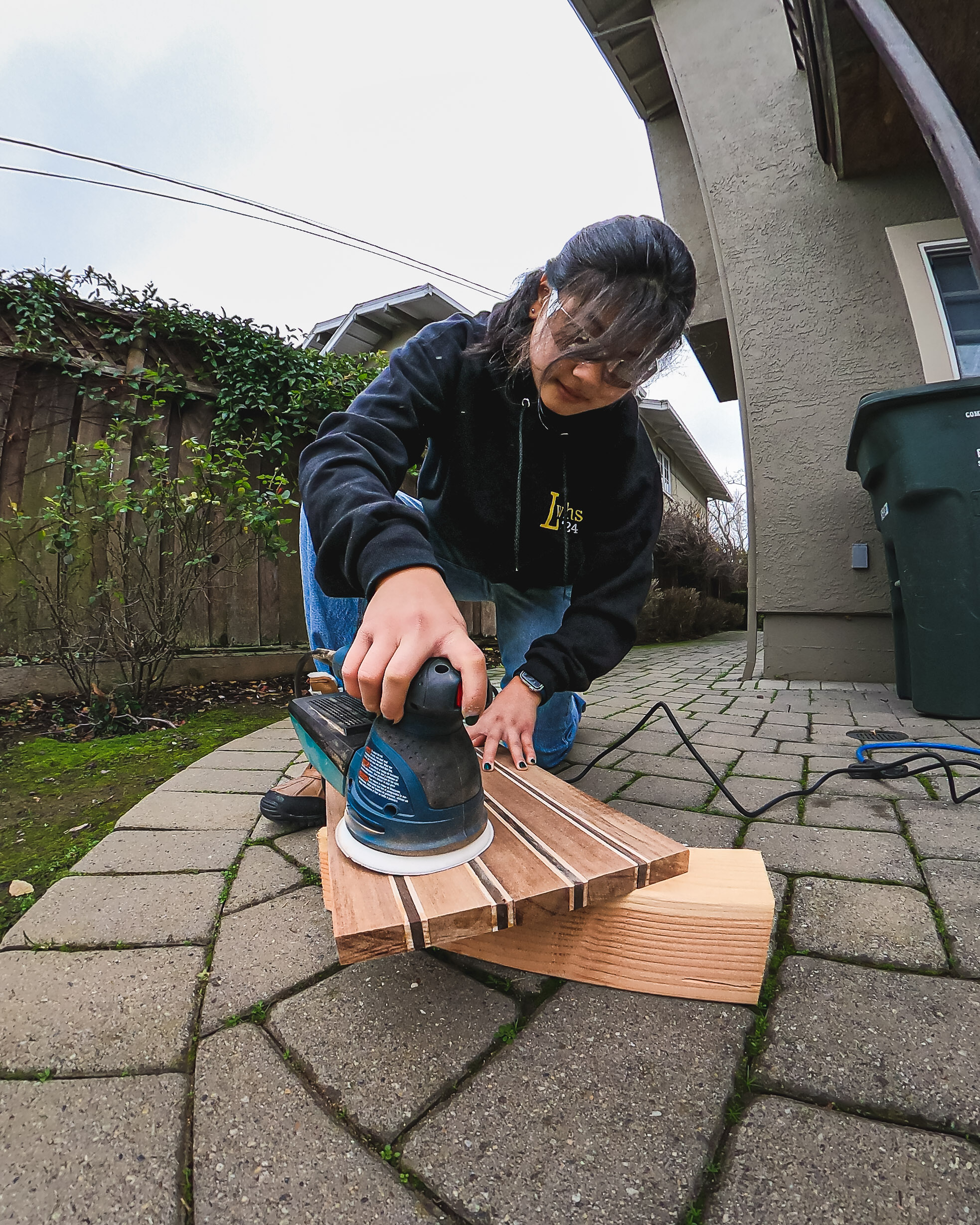 Emmie disc sanding a cutting board